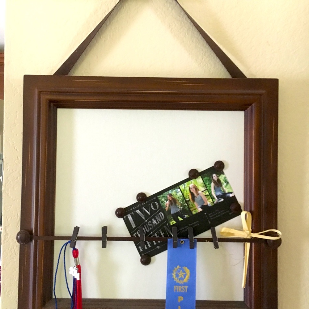 Display memories and memorabilia with this brown wood, magnetic hanging frame